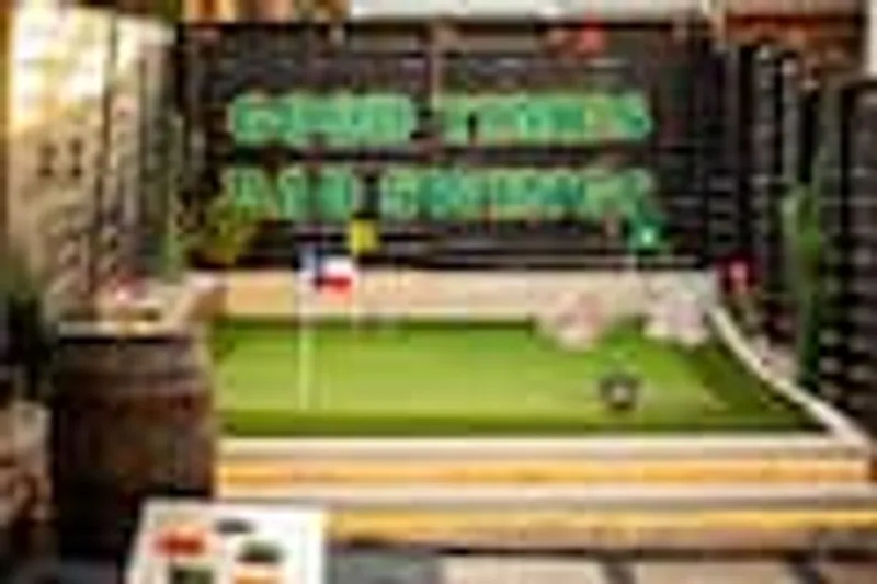 Backyard putting green with Good Times Bad Swings neon