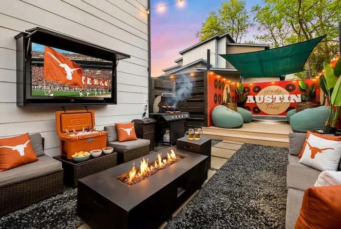 Backyard fire pit lounge with outdoor TV