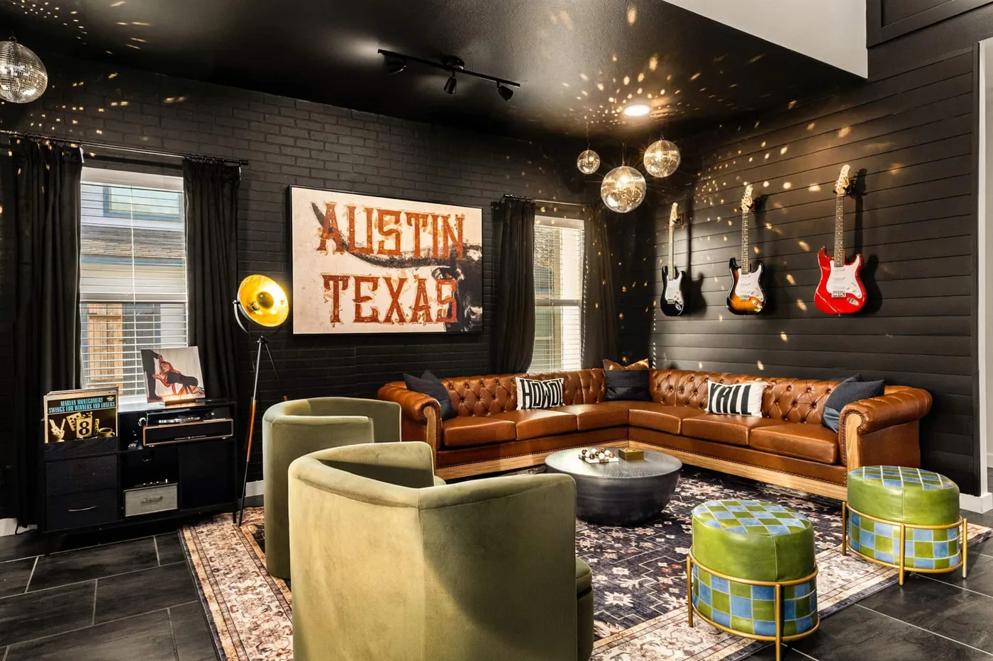 The lounge — neon Austin Texas sign, guitars, leather chesterfield