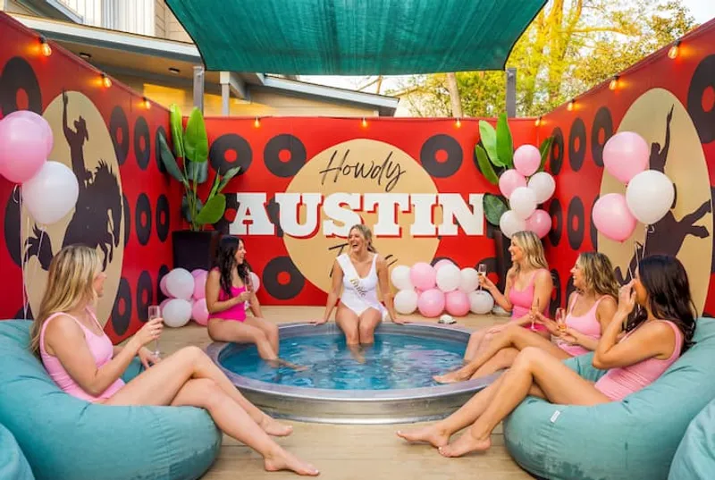 Cowboy pool party in front of the Howdy Austin mural